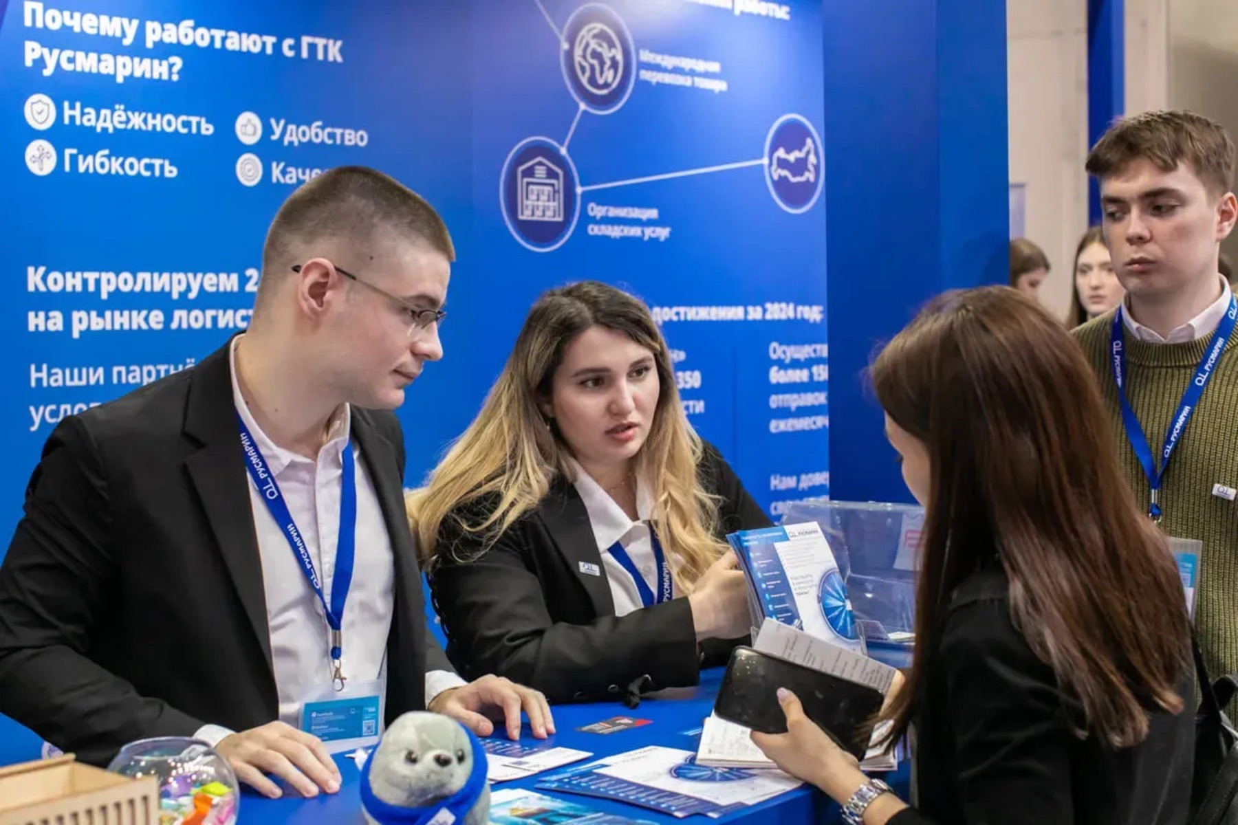 Visitors engaging with a modern exhibition stand at a business event